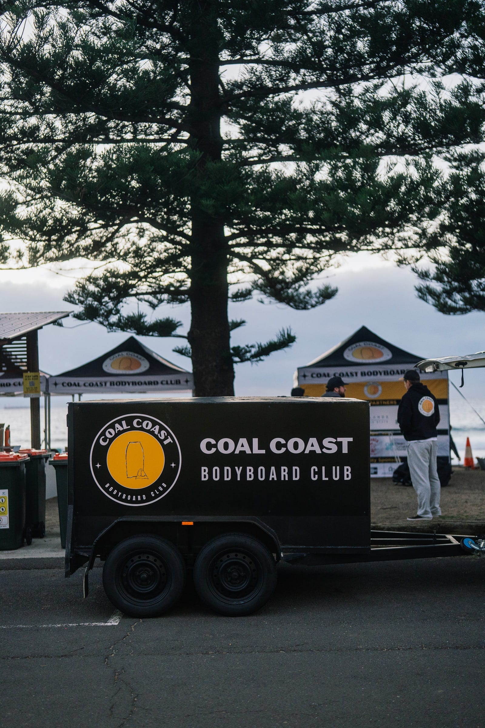 The Coal Coast Bodyboard Club trailer parked beside the club marquees